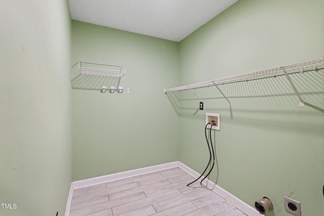 washroom featuring washer hookup, laundry area, baseboards, hookup for an electric dryer, and wood tiled floor