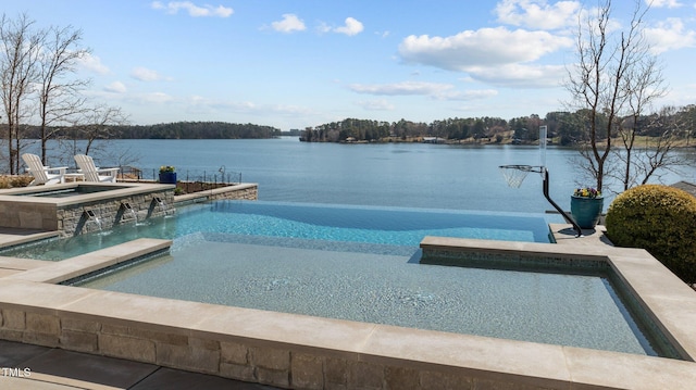 view of swimming pool featuring a patio area, an in ground hot tub, an infinity pool, and a water view