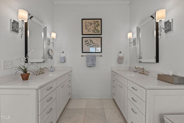 full bath with ornamental molding, two vanities, and a sink