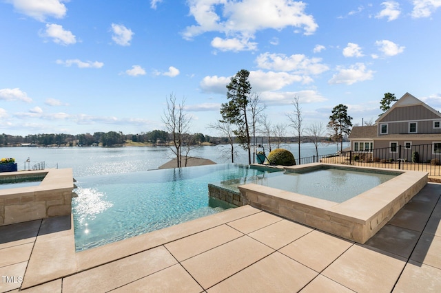 view of swimming pool with a water view, an in ground hot tub, an infinity pool, and a patio area