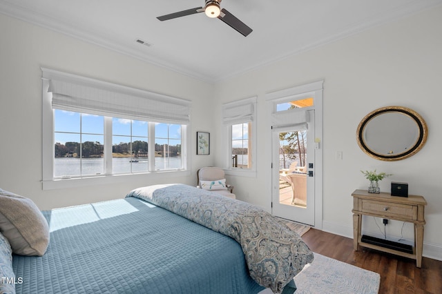 bedroom featuring visible vents, multiple windows, wood finished floors, and crown molding