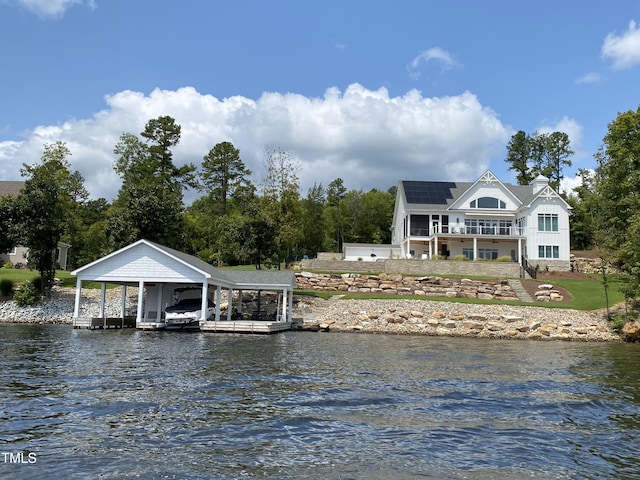 view of dock with boat lift and a water view