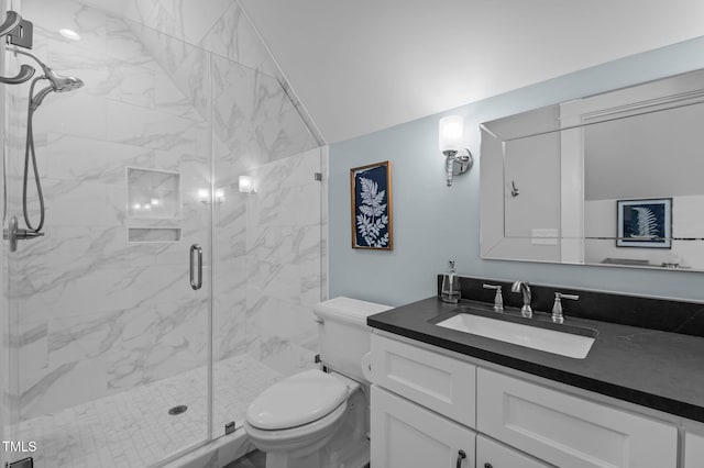 full bath featuring a marble finish shower, toilet, and vanity