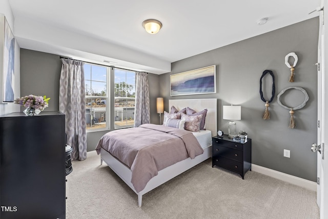 bedroom featuring carpet flooring and baseboards