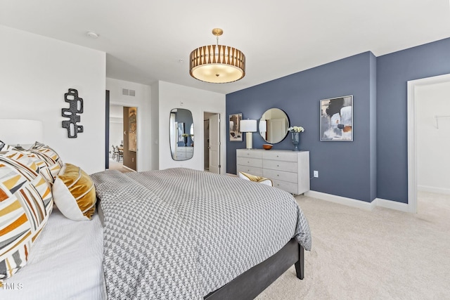 carpeted bedroom with visible vents and baseboards