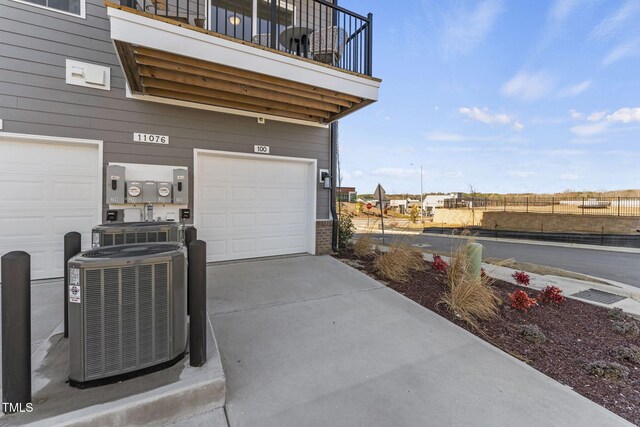 garage with cooling unit and driveway