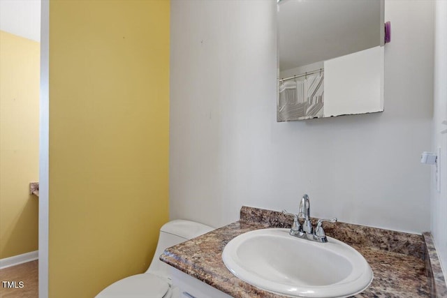 bathroom featuring toilet and vanity