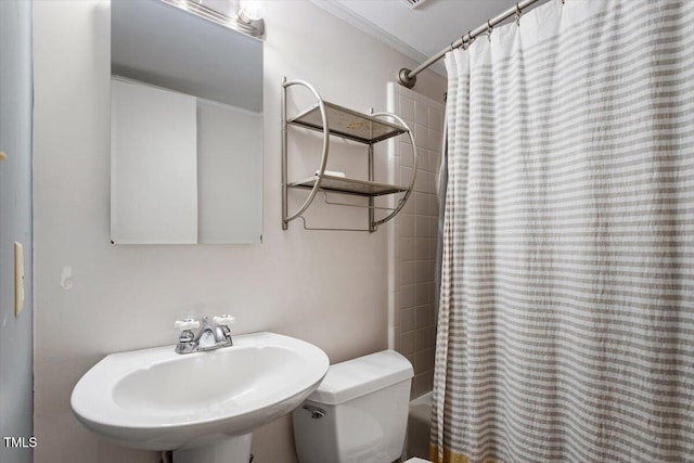 full bathroom featuring shower / bathtub combination with curtain, toilet, and a sink