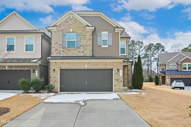 view of front of house with concrete driveway, an attached garage, and brick siding