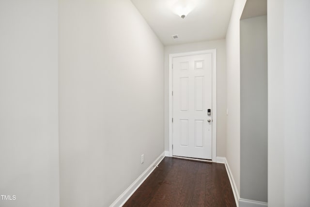 doorway to outside with visible vents, dark wood-style floors, and baseboards