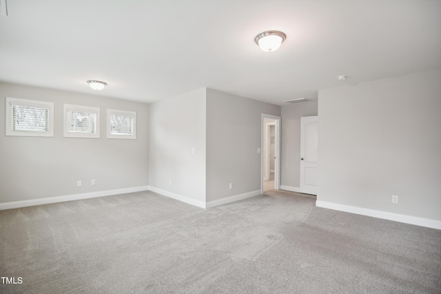 empty room featuring baseboards and carpet floors