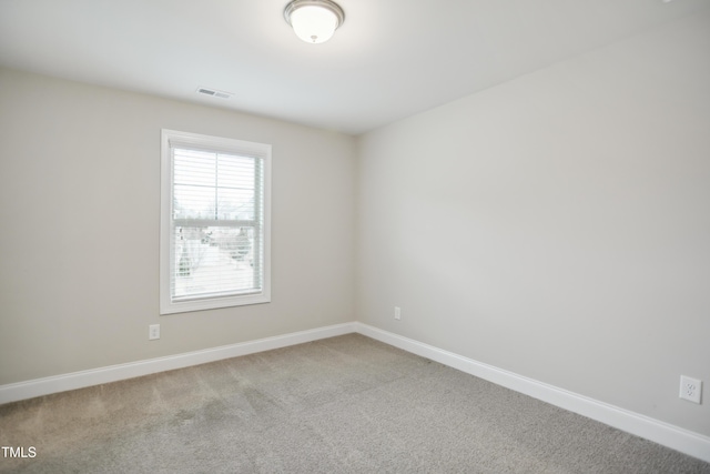 spare room featuring visible vents, baseboards, and carpet floors