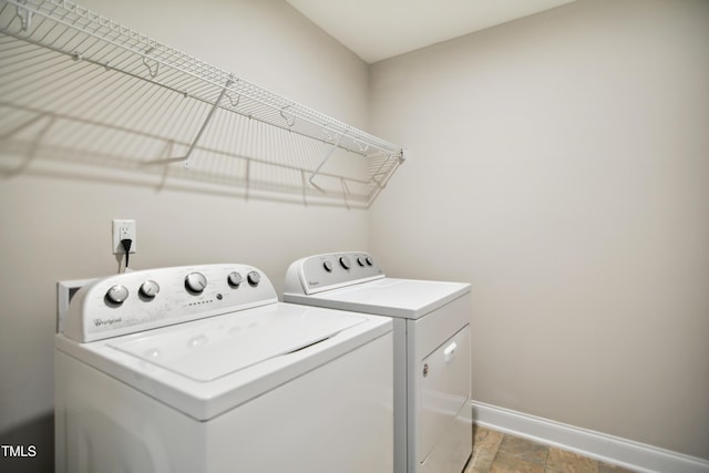 laundry room featuring baseboards, washing machine and dryer, and laundry area