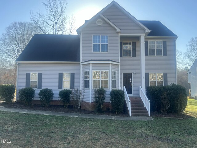 traditional-style home with a front lawn