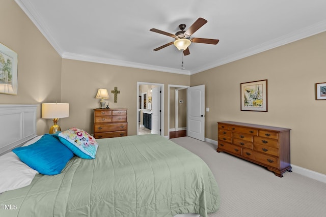 bedroom featuring baseboards, carpet floors, ceiling fan, ensuite bathroom, and crown molding