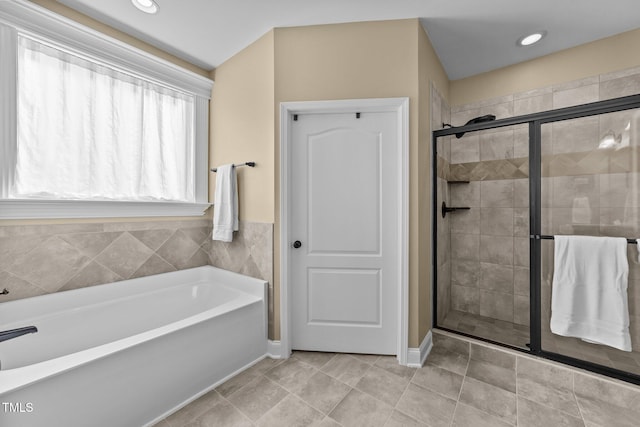 full bathroom featuring recessed lighting, a stall shower, tile patterned flooring, and a bath