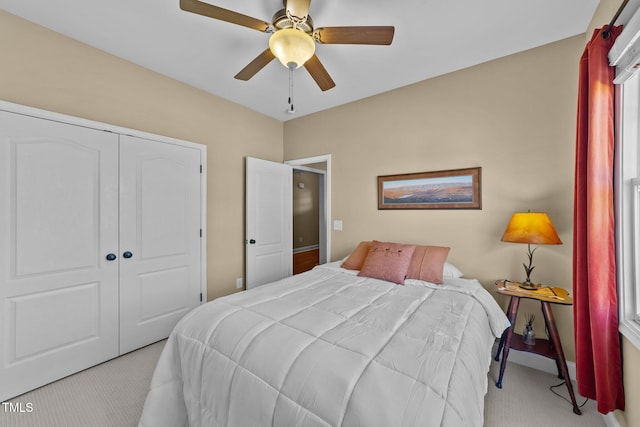 bedroom with light carpet, a closet, and ceiling fan