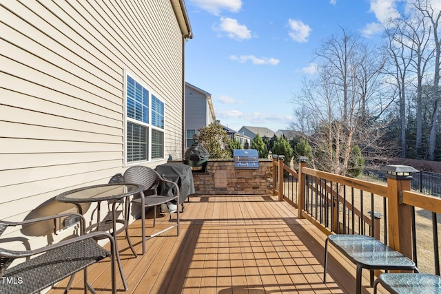 deck with a grill and exterior kitchen