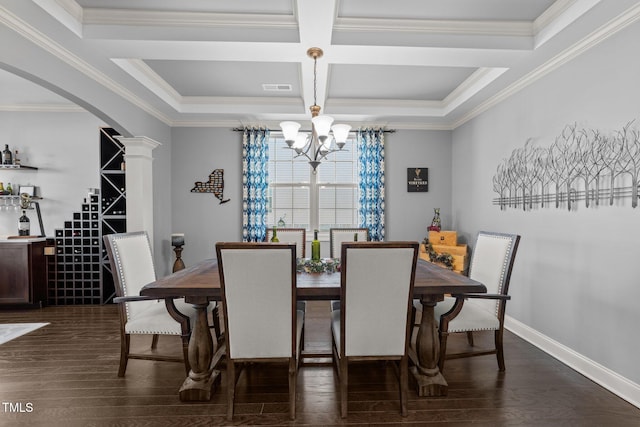 dining area featuring visible vents, ornate columns, arched walkways, dark wood-type flooring, and a chandelier