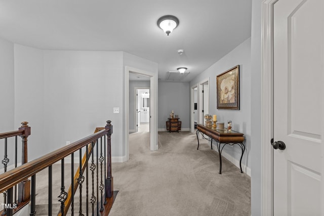 corridor featuring an upstairs landing, carpet flooring, and baseboards