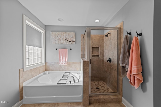 bathroom featuring recessed lighting, baseboards, a garden tub, and a stall shower