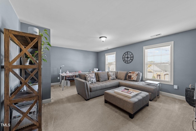 living area with carpet, visible vents, and baseboards