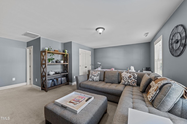 living room with visible vents, baseboards, and carpet