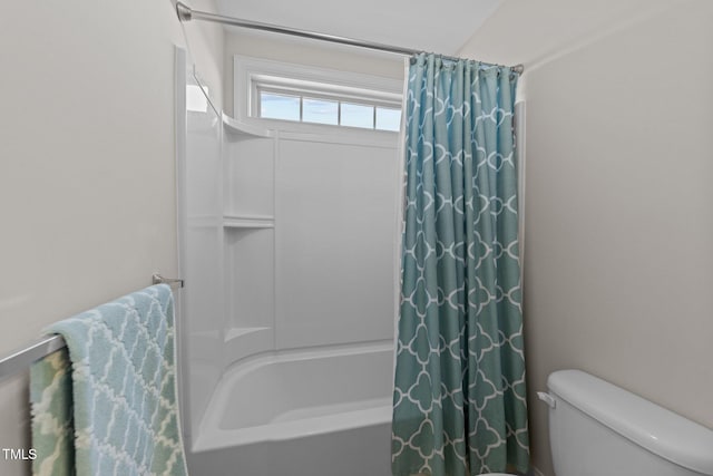 bathroom with shower / bath combination with curtain and toilet