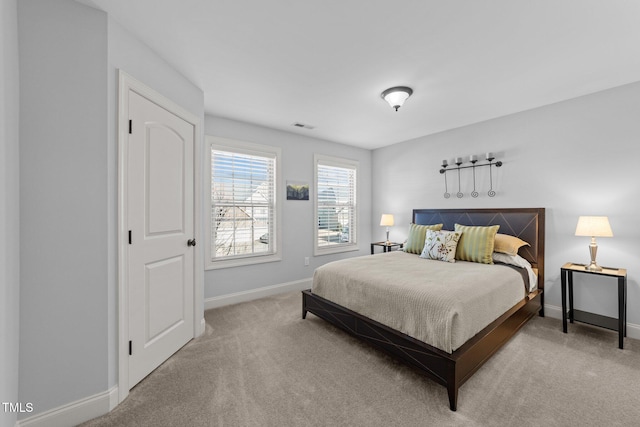 carpeted bedroom with visible vents and baseboards