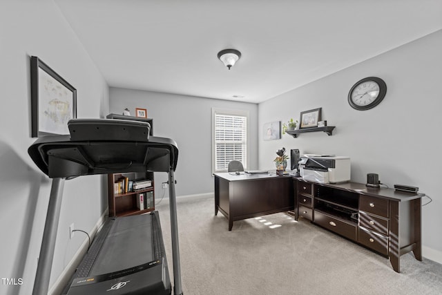 home office featuring baseboards and light colored carpet