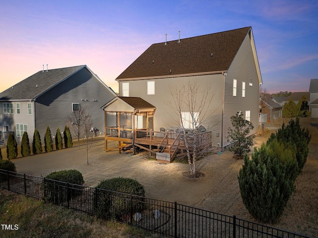 rear view of house featuring a deck, a gazebo, and fence