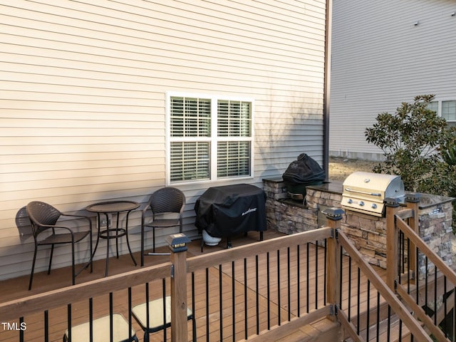 wooden deck with a patio and a grill