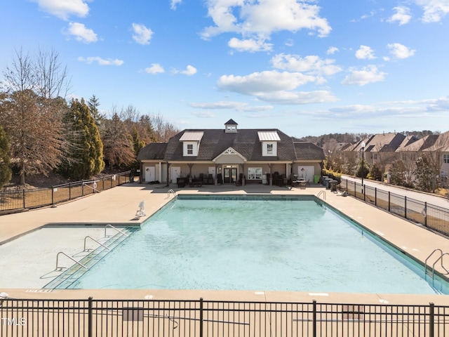 pool with fence and a patio area