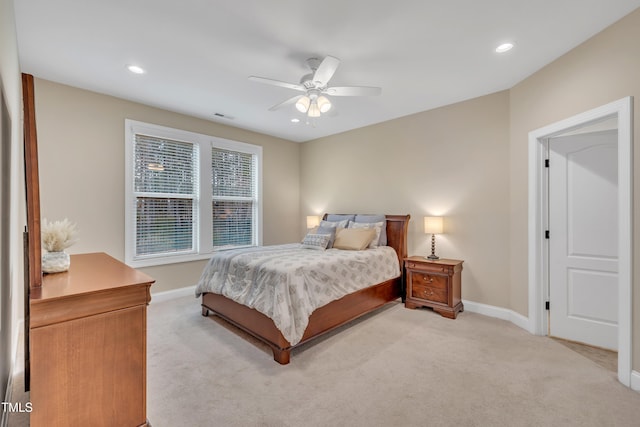 bedroom with light colored carpet, visible vents, and baseboards