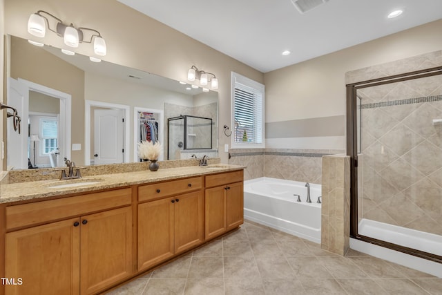 bathroom featuring visible vents, a sink, a shower stall, tile patterned floors, and a bath