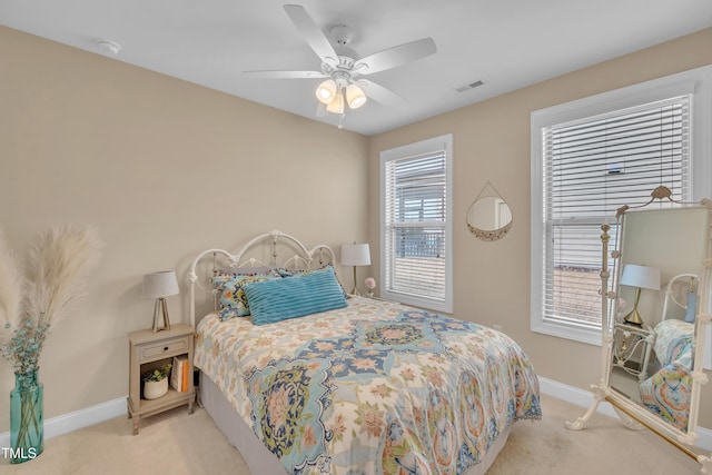 bedroom with baseboards, visible vents, carpet floors, and ceiling fan