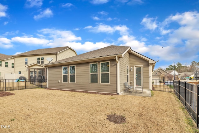 rear view of house with a patio area and a fenced backyard