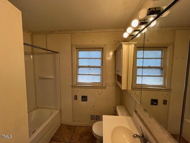 full bathroom featuring tile patterned floors, toilet, shower / washtub combination, crown molding, and vanity