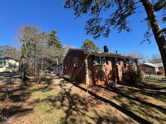 view of property exterior with brick siding