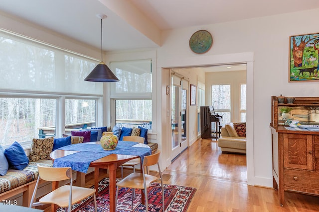 dining area featuring baseboards and light wood-type flooring