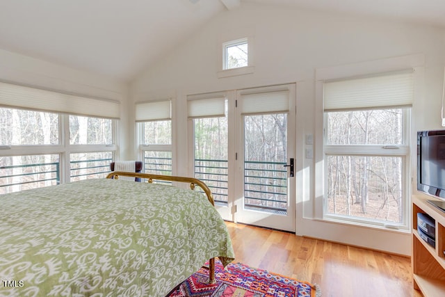 bedroom featuring beam ceiling, access to outside, light wood-style flooring, and high vaulted ceiling