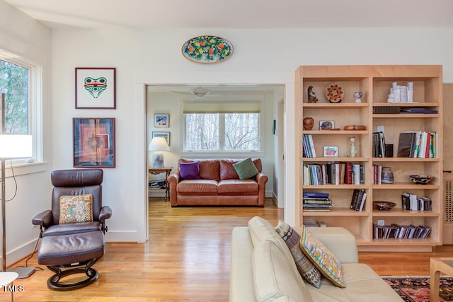 sitting room featuring a wealth of natural light, baseboards, and wood finished floors