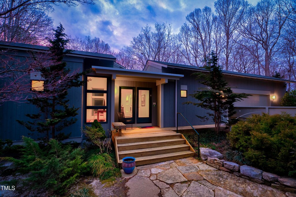 3604 Pasture Rd, Hillsborough, NC 27278 - exterior entry at dusk featuring an attached garage