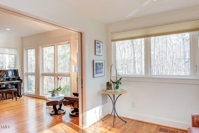 living area featuring wood finished floors, visible vents, and a wealth of natural light