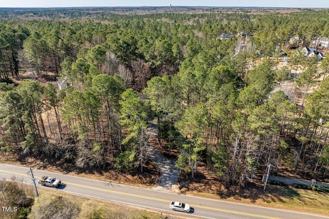 birds eye view of property with a view of trees