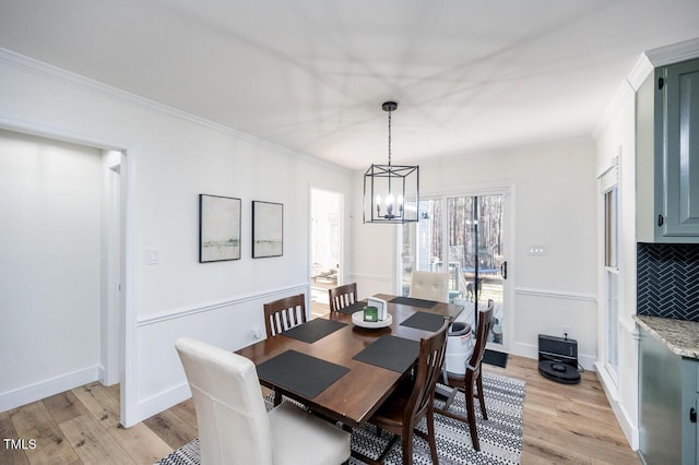 dining room featuring light wood-type flooring and ornamental molding