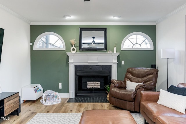 living room featuring plenty of natural light, a fireplace with flush hearth, and wood finished floors