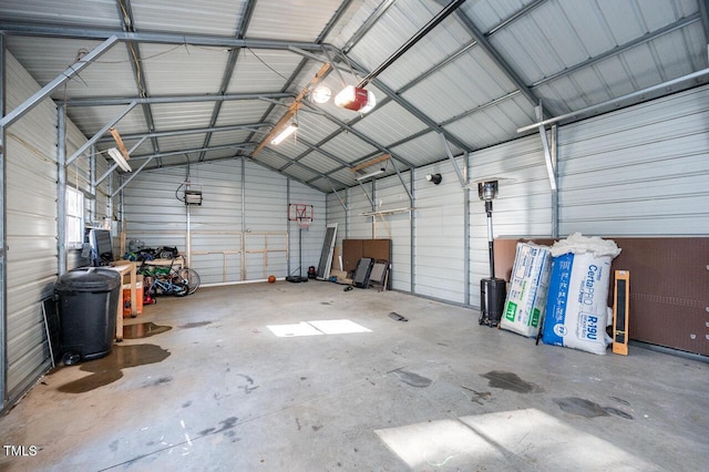 garage with a garage door opener and metal wall