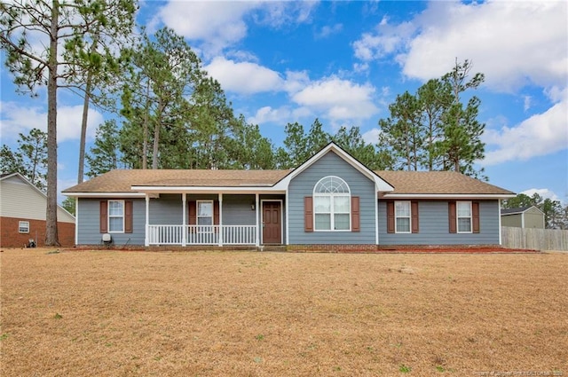 ranch-style house with a porch, a front lawn, and fence