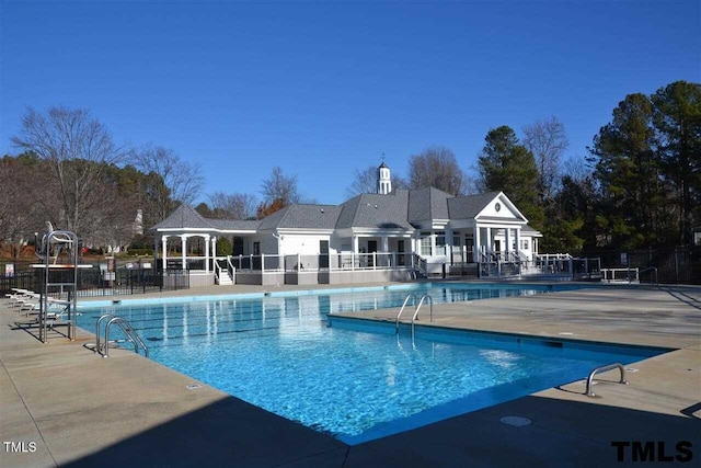 community pool featuring a gazebo, a patio, and fence